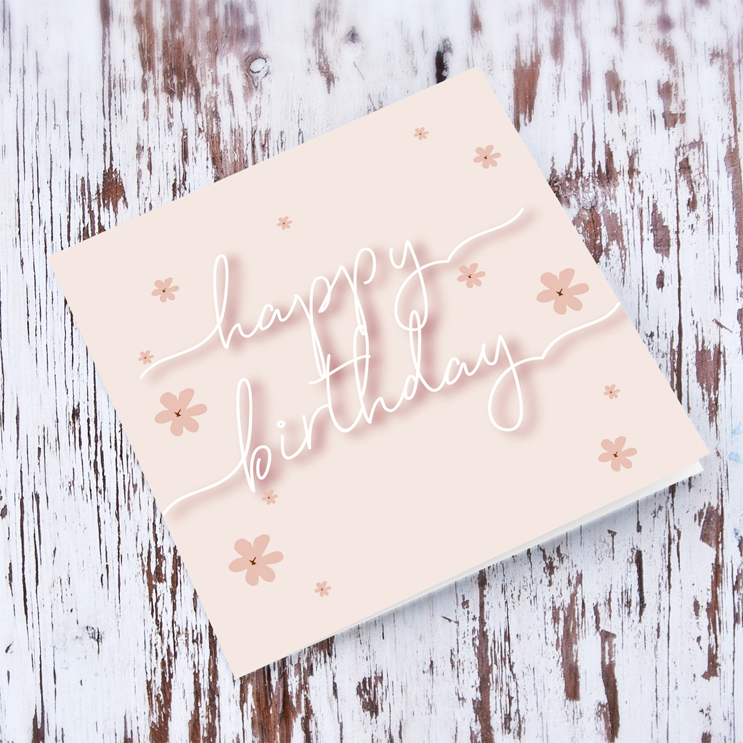 Pink background with petite scattered flowers and white text birthday card in English
