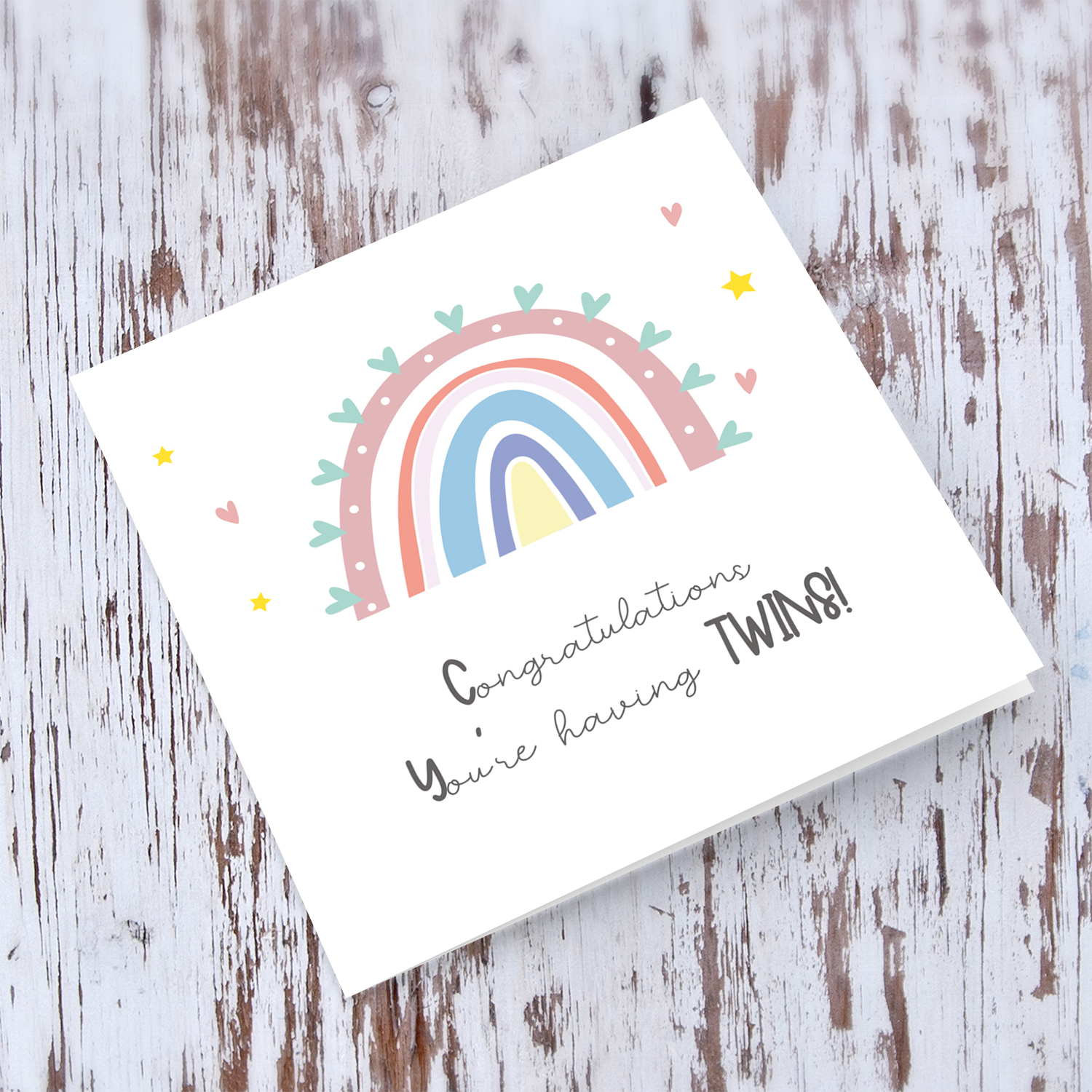 Rainbow themed baby shower card for twins with heats and stars in English