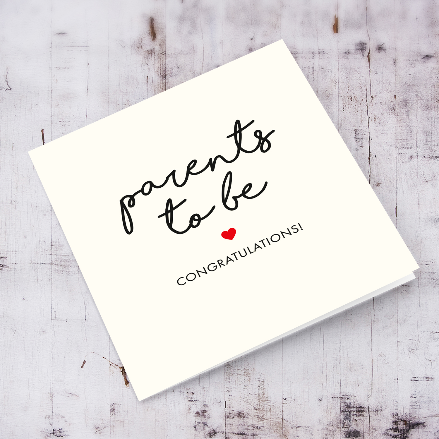 Minimalist baby shower card with red heart to parents to be in English