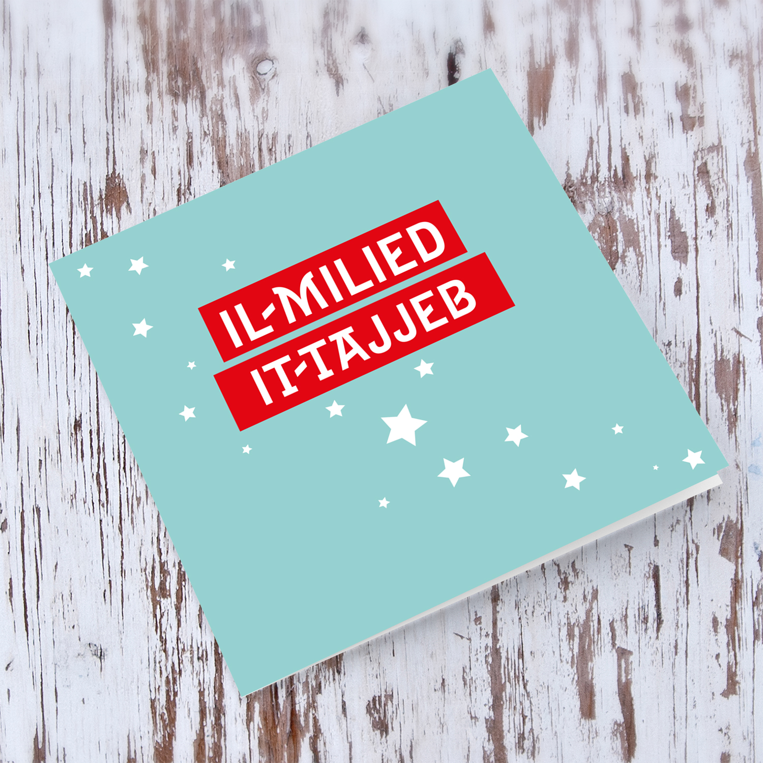 Light blue background with red rectangles and scattered stars Christmas card in Maltese