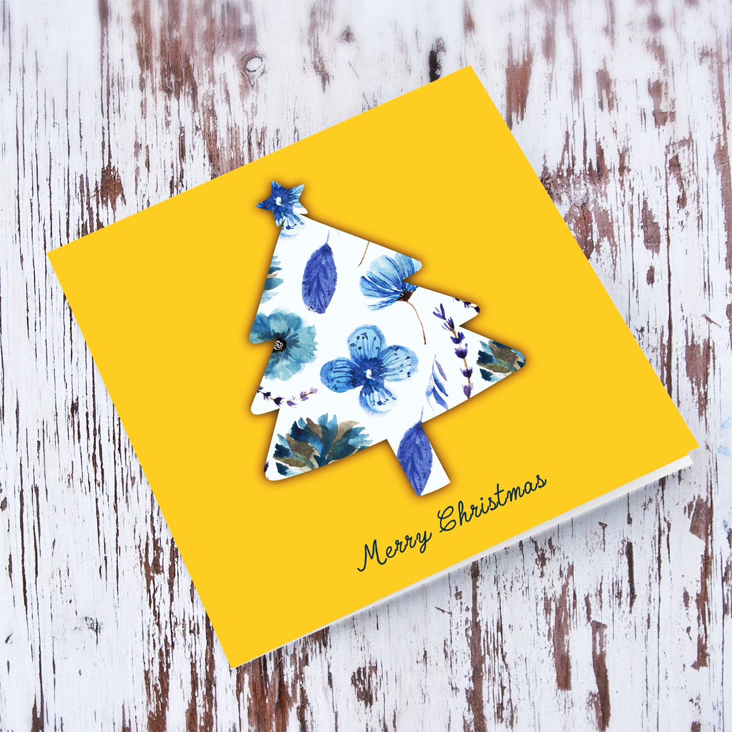 Shades of blue flowery Christmas tree shaped card in bright coloured background in English