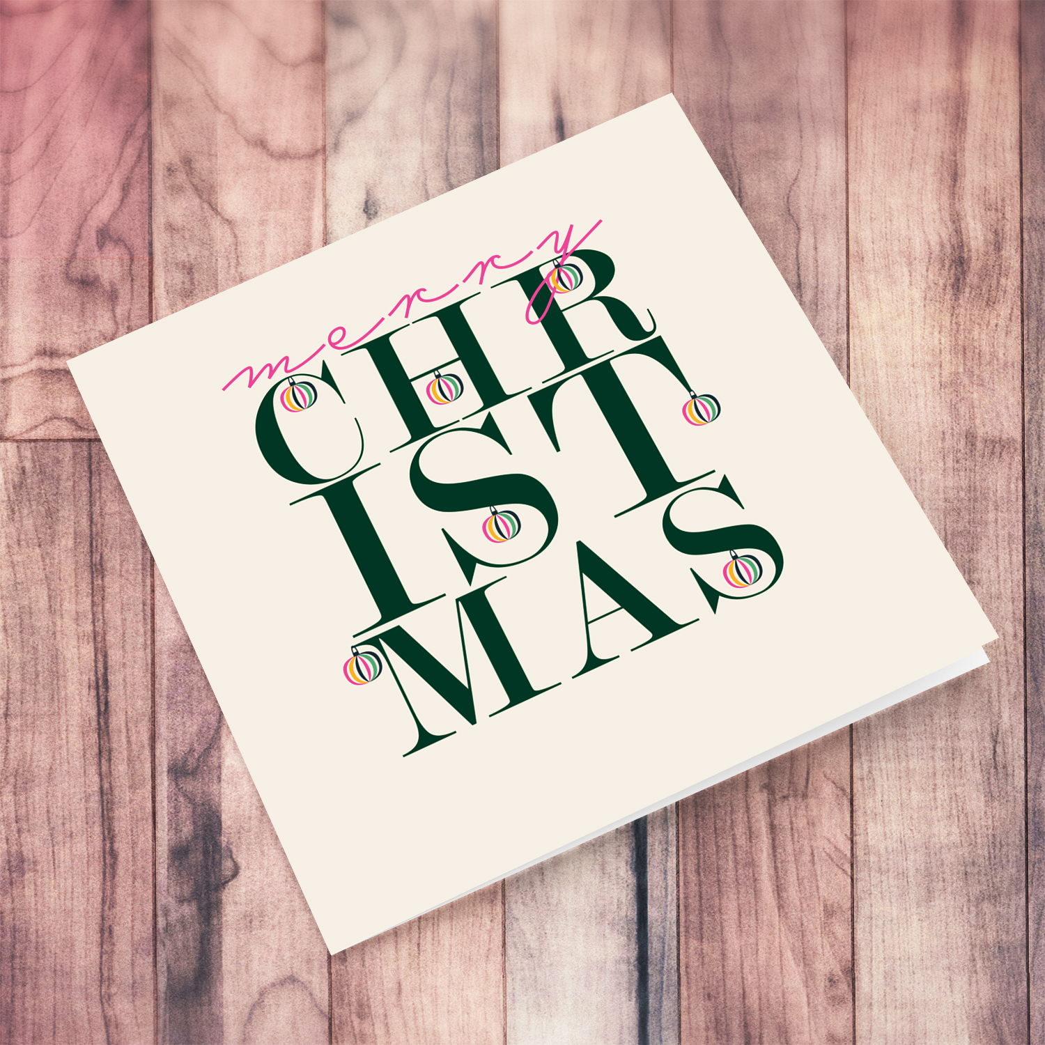 An open beautiful, modern Christmas card, in the holiday's season colours and some pink with various hanging baubles in English (Unisex and Neutral)