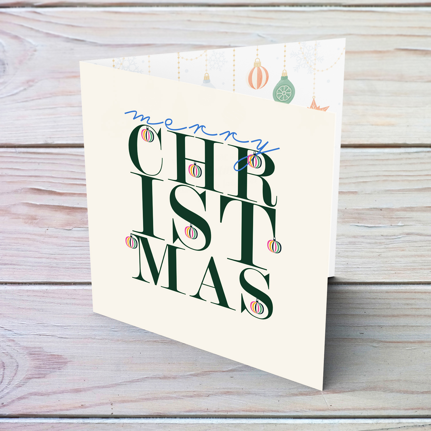 An open beautiful, modern Christmas card, in the holiday's season colours and some blue with various hanging baubles in English (Unisex and Neutral)