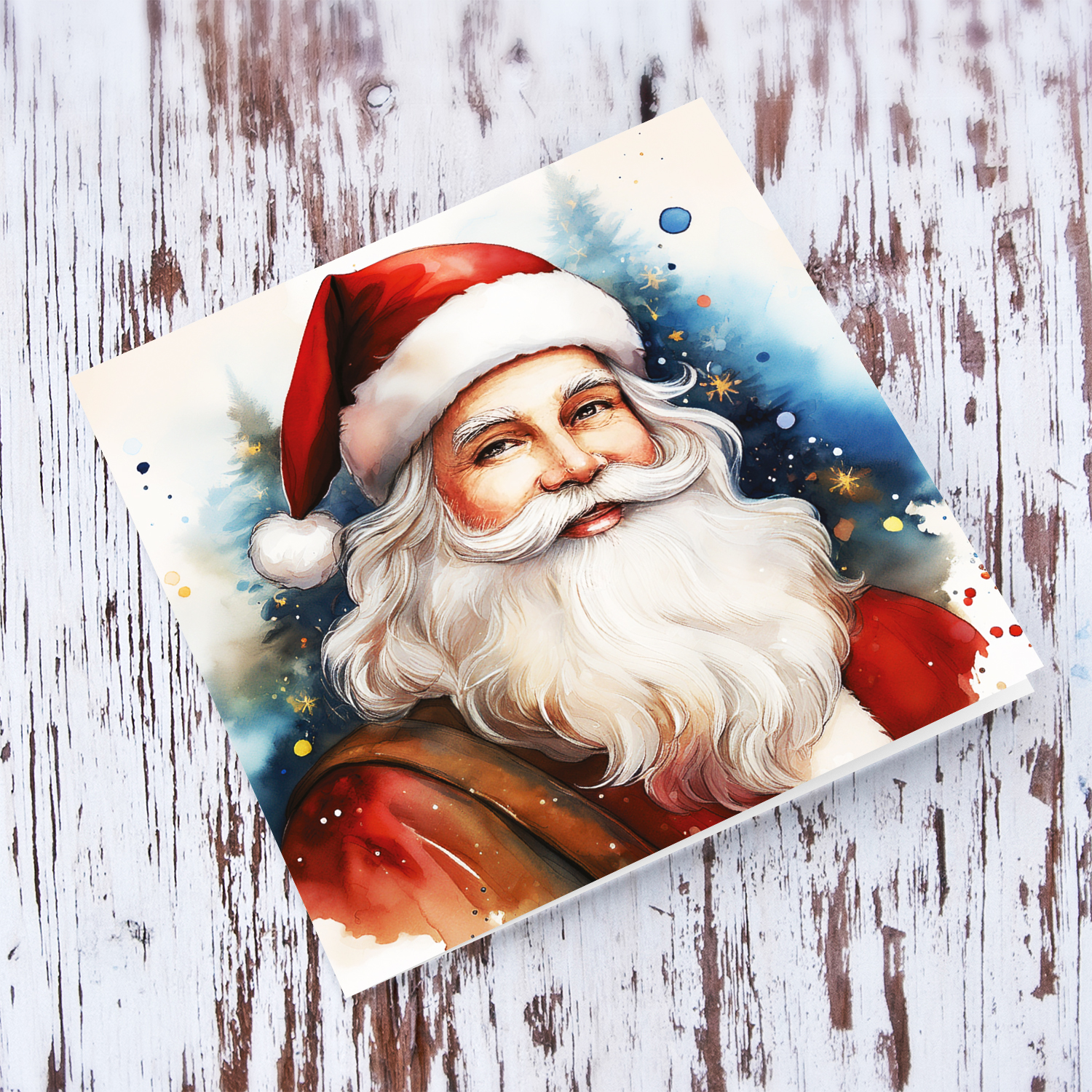 An open Christmas card featuring St Nicholas / Santa Claus with a bluish watercolour background in Maltese