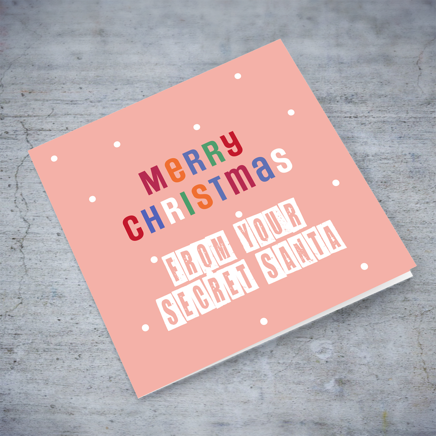 An cute Christmas card in a light pink background with colourful text - from your secret santa in English