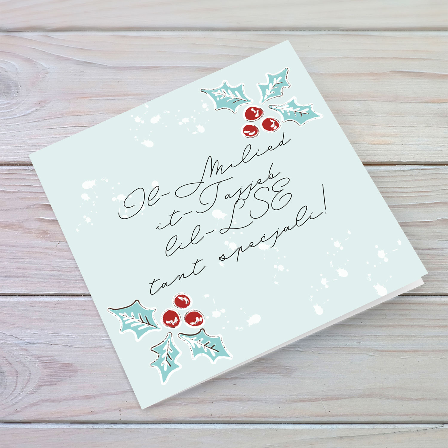 Christmas holly, scattered snow, and light background Christmas card in for a special LSE in Maltese