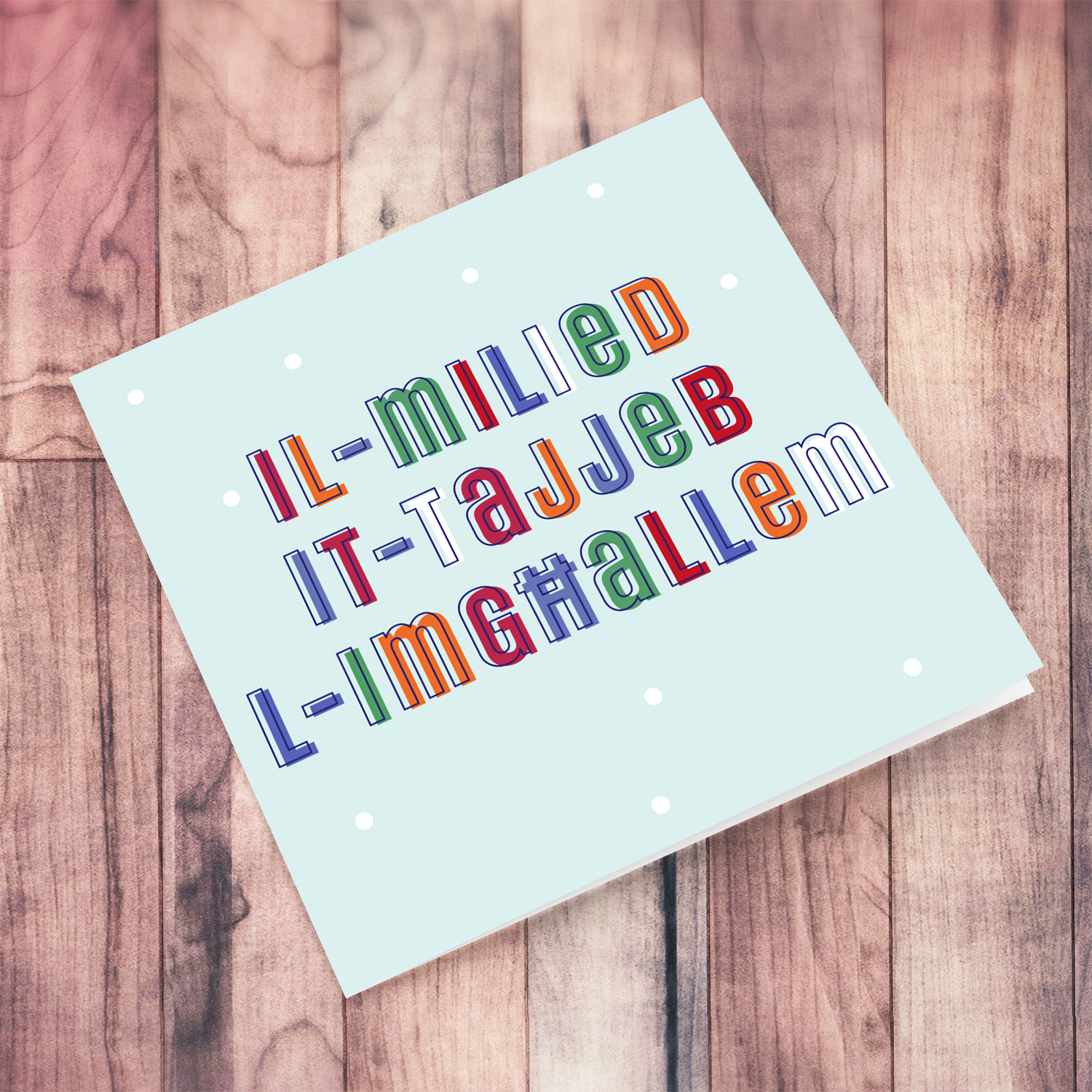 A cute Christmas card in a light blue background with colourful text for Boss in Maltese