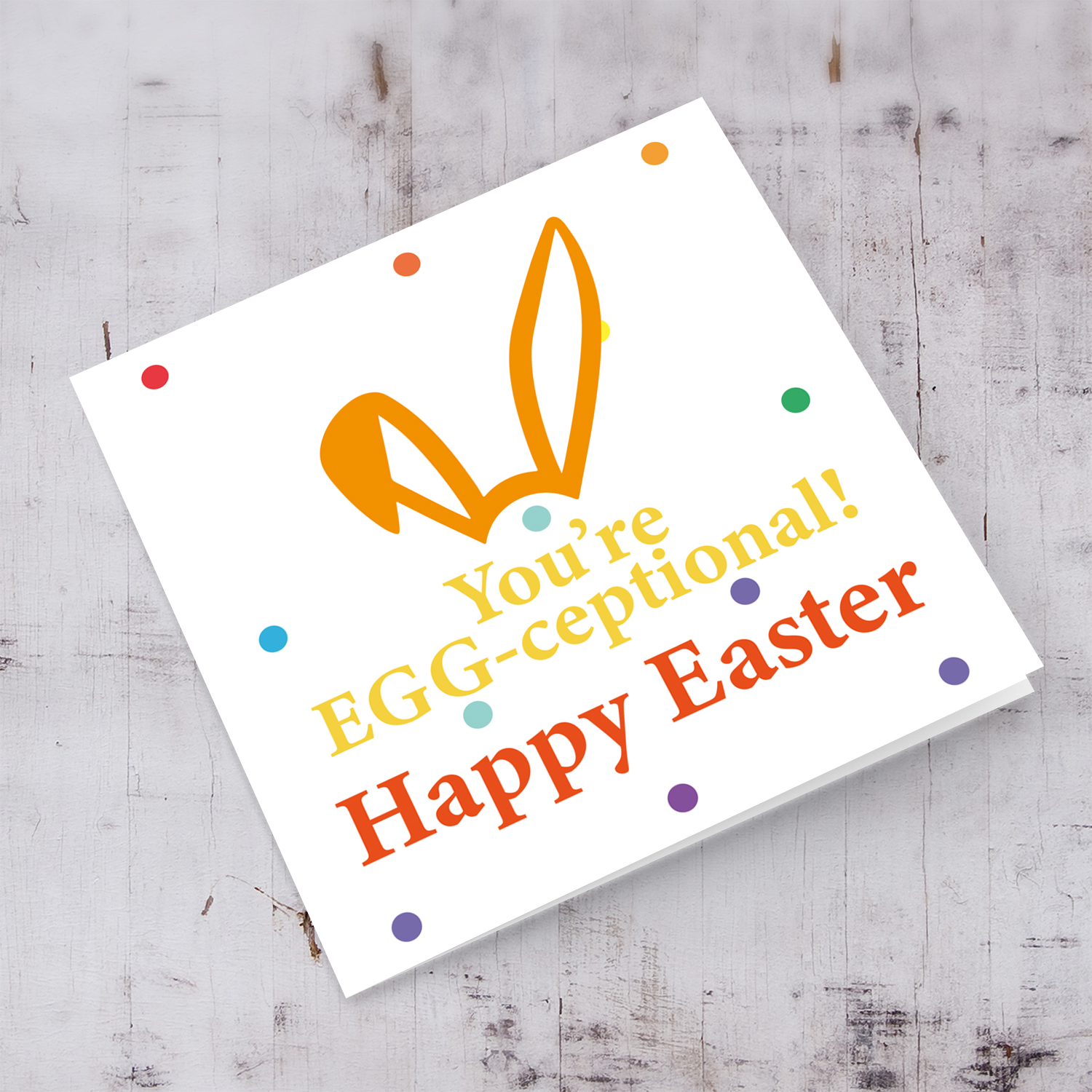 Colourful bunny ears Easter card with colourful dots in the background in English