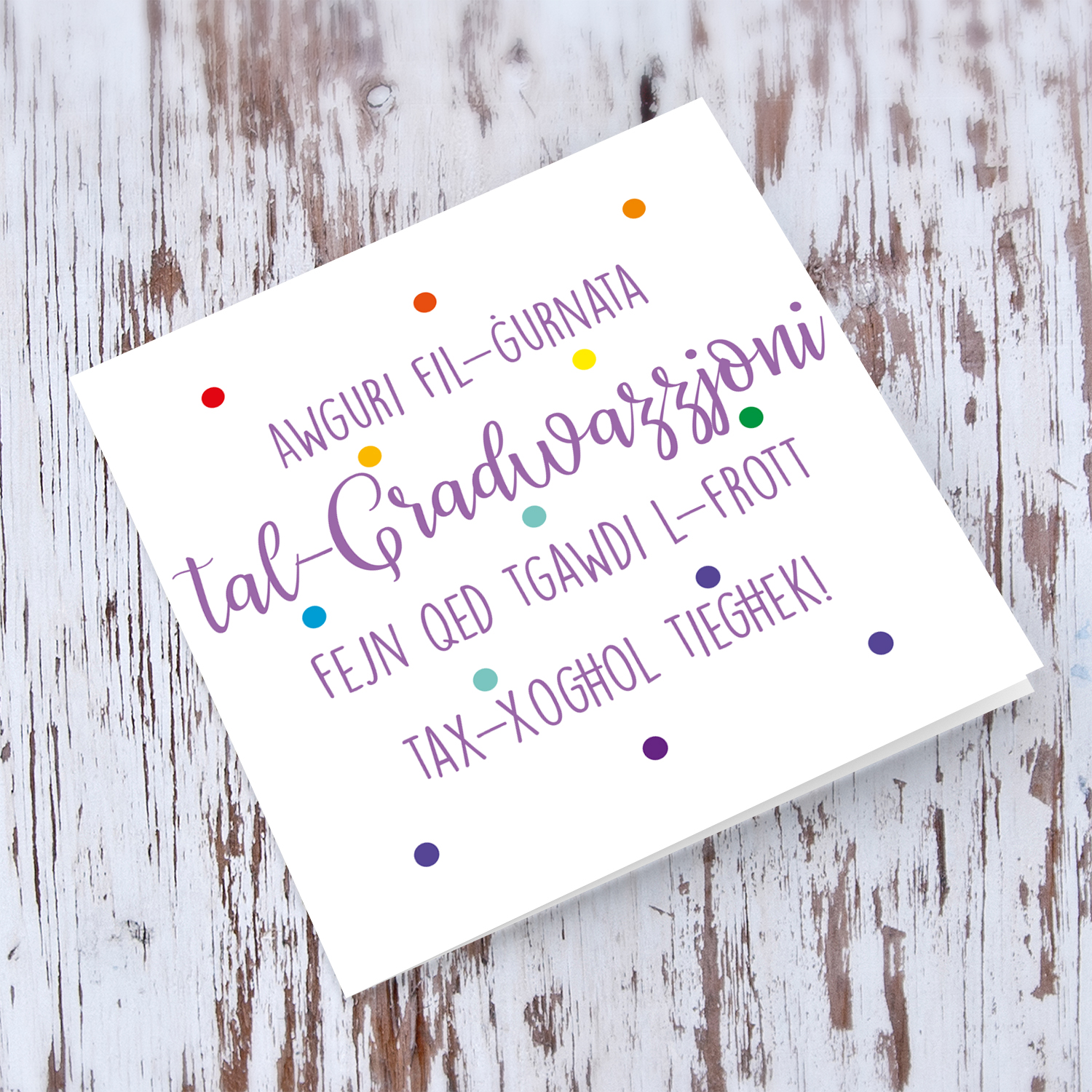 Colourful polka dot Graduation card in purple text in Maltese