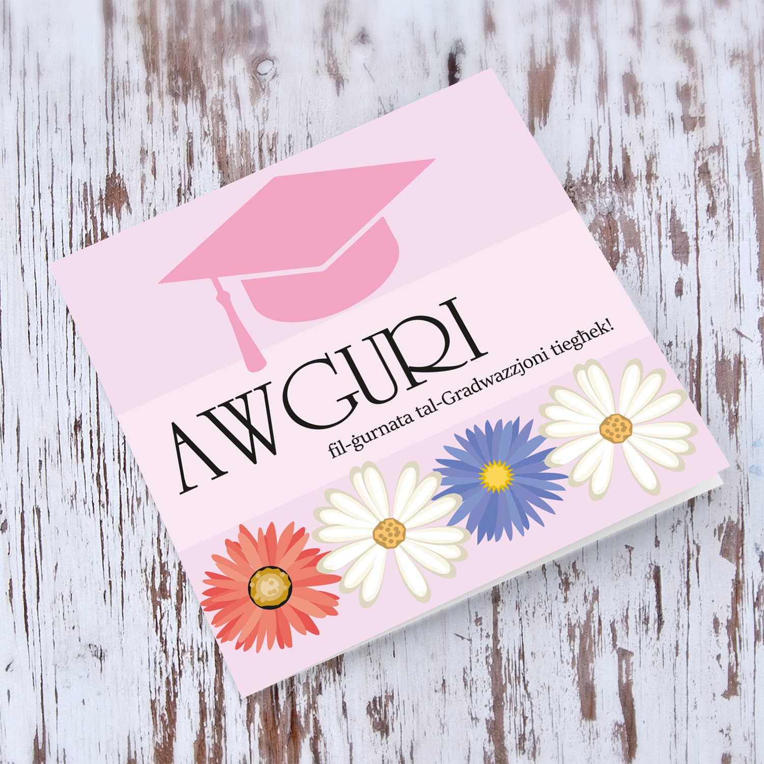 Pink Graduation hat card with red, blue and white flowers in Maltese