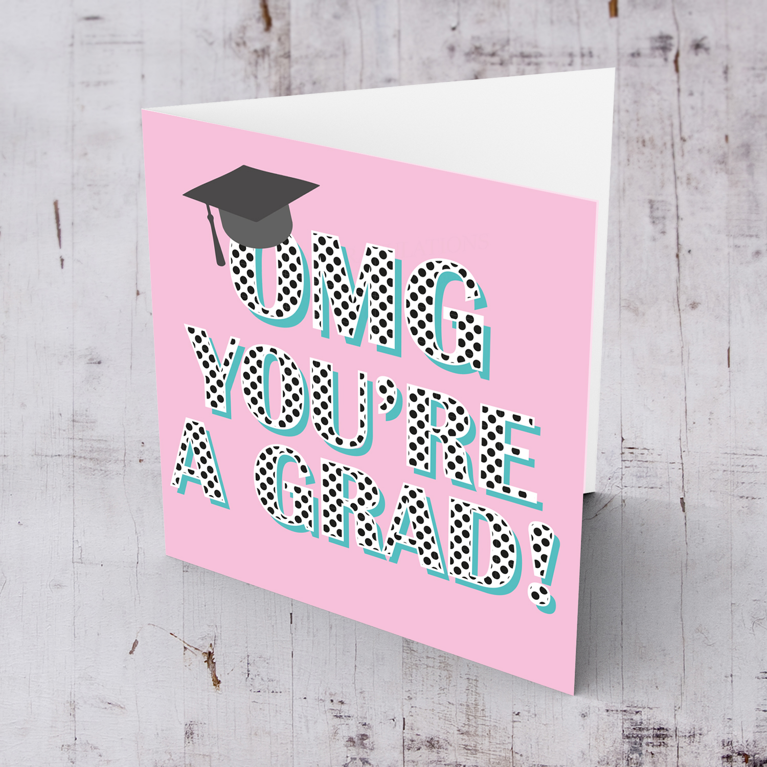 Pink background graduation card with polka dot wording and graduation hat in English