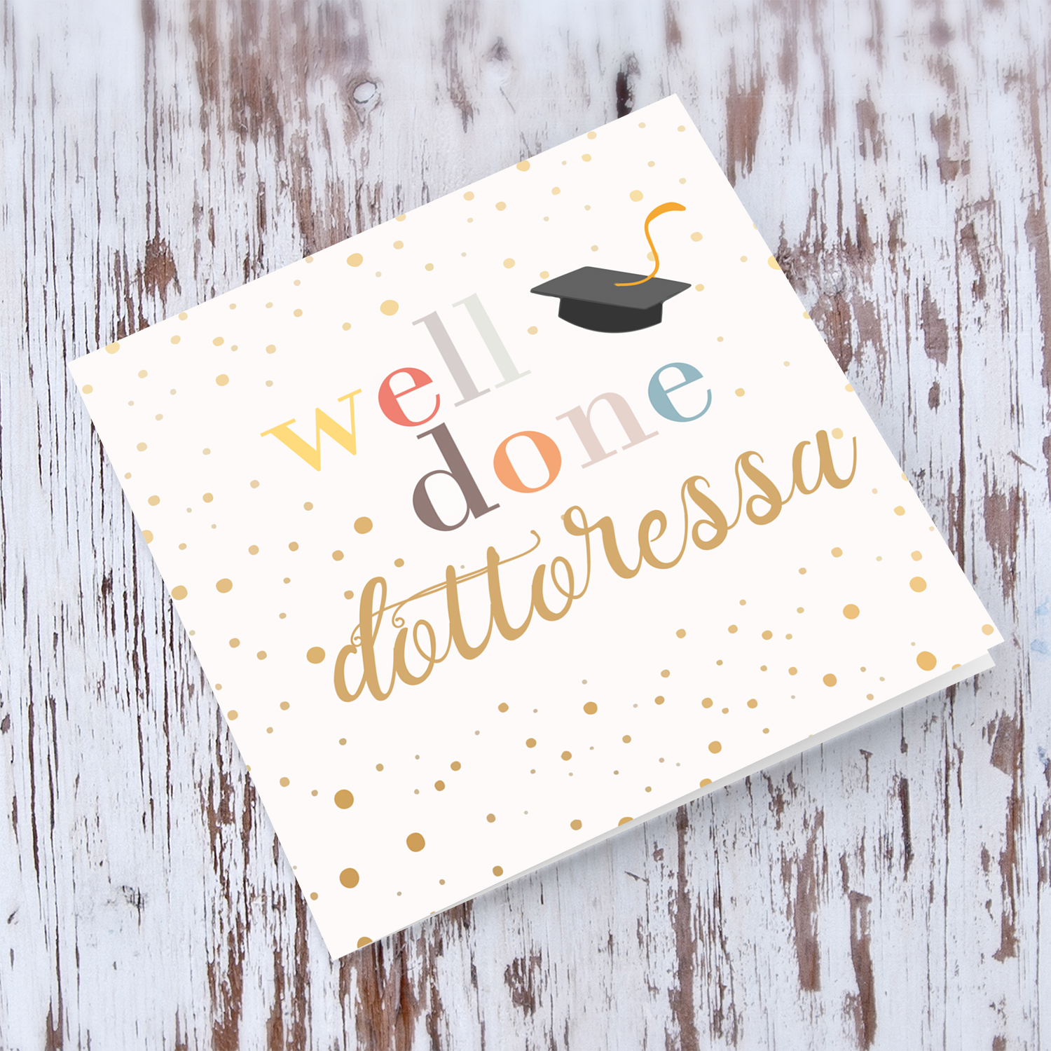 Well Done card - dottoressa with colourful text, graduation hat and scattered spots in English