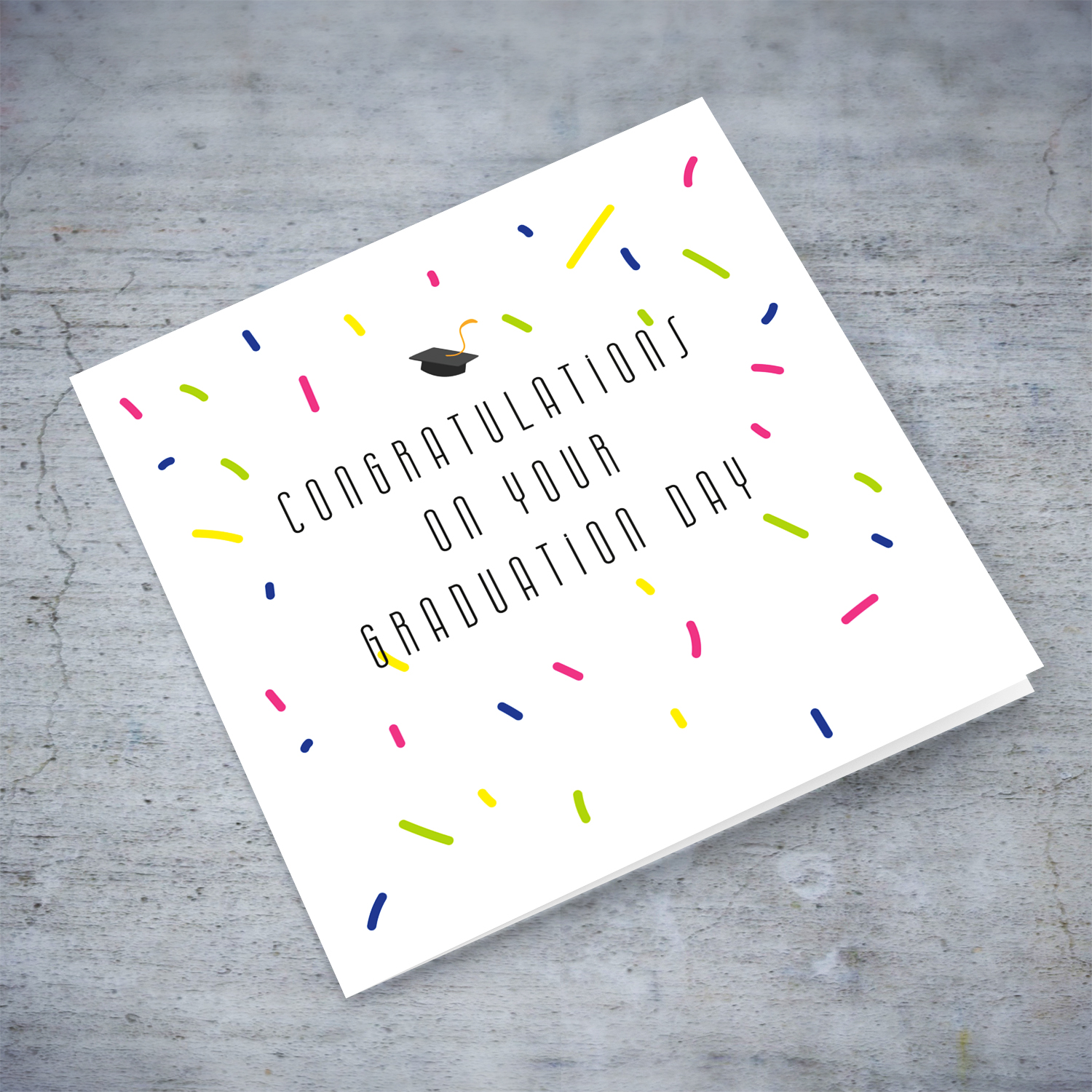 Colourful graduation card with scattered confetti and small graduation hat in English