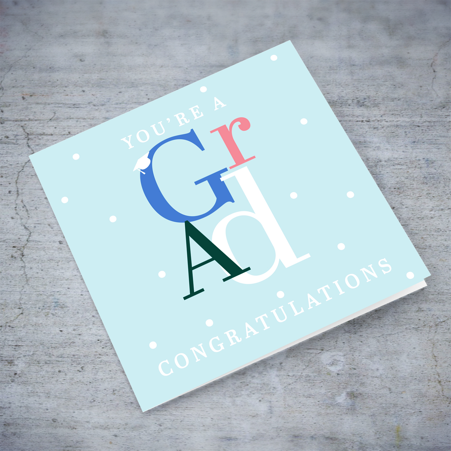 Modern graduation card in light blue background, featuring colourful GRAD and other white text in English