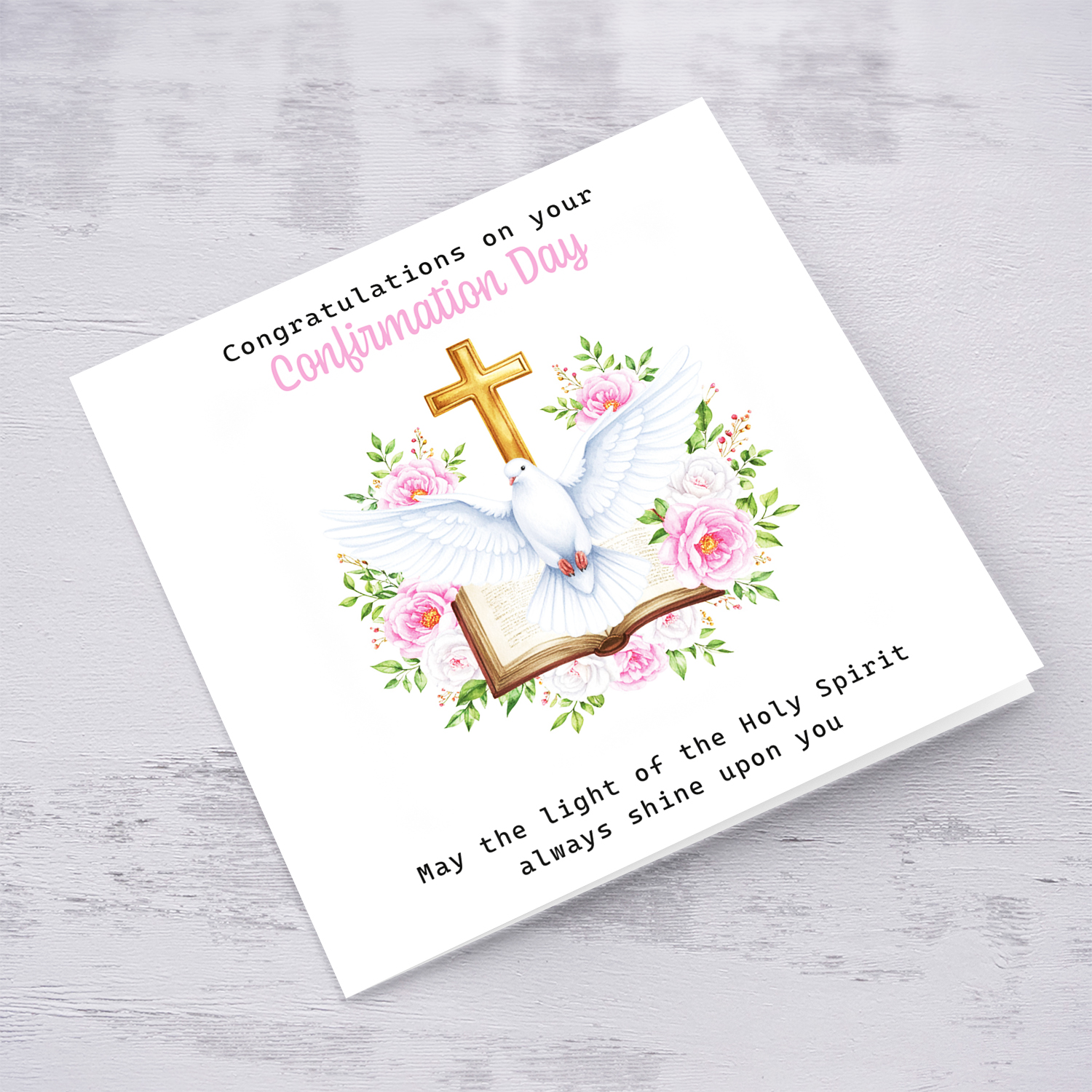 An open Confirmation card for Girls featuring the Holy Spirit dove, an open Bible and beautiful pink and white flowers in English