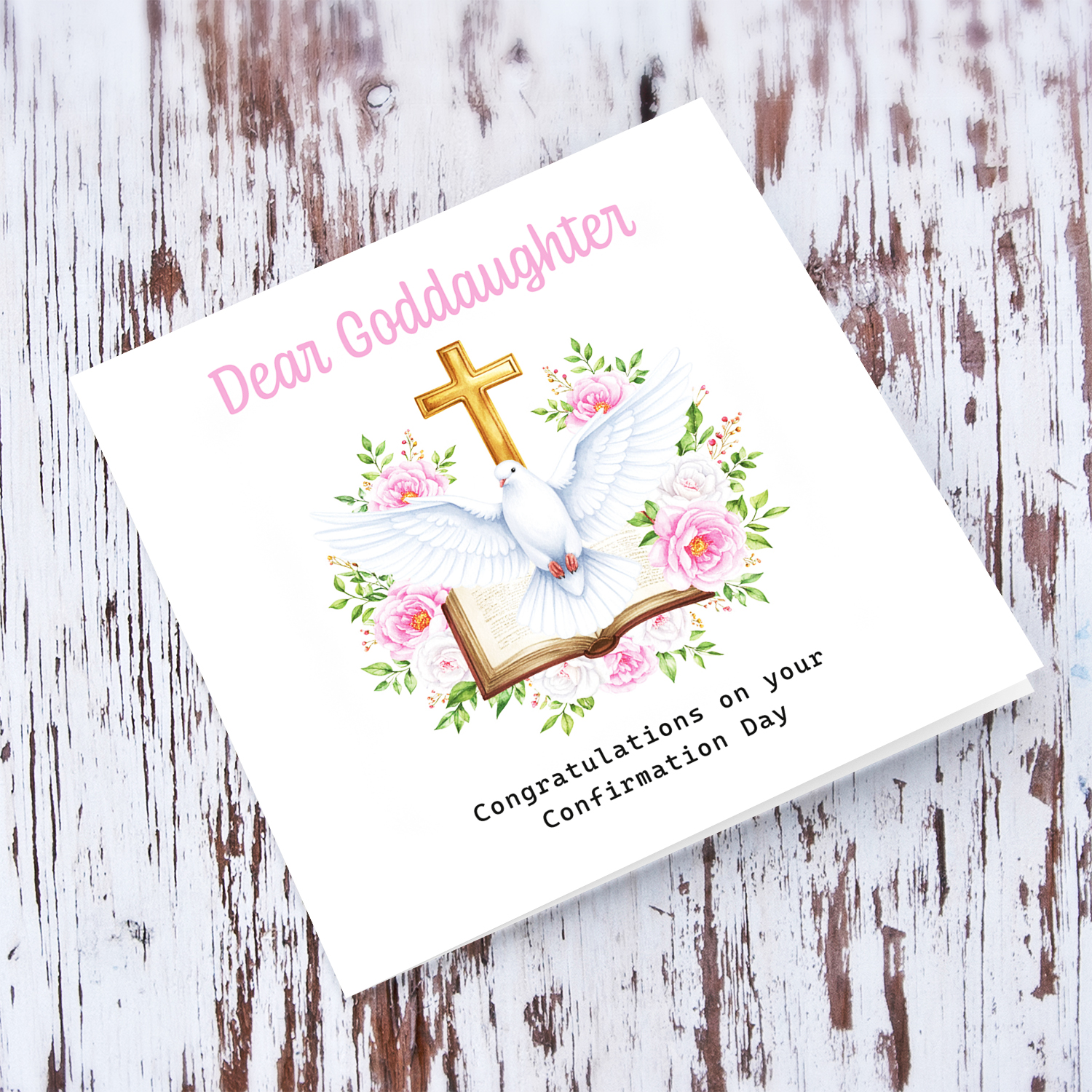 An elegant Confirmation card for Goddaughter featuring the Holy Spirit dove, an open Bible and beautiful pink and white flowers in English
