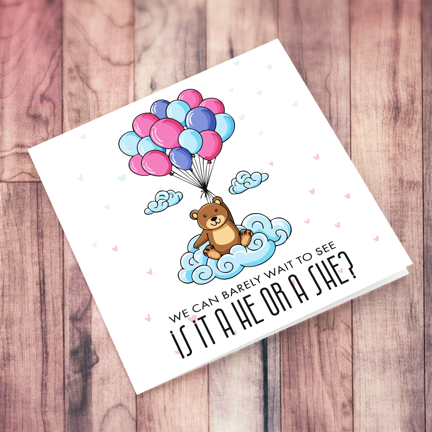 A cute bear holding blue, pink and purple balloons gender reveal card with scattered hearts in English