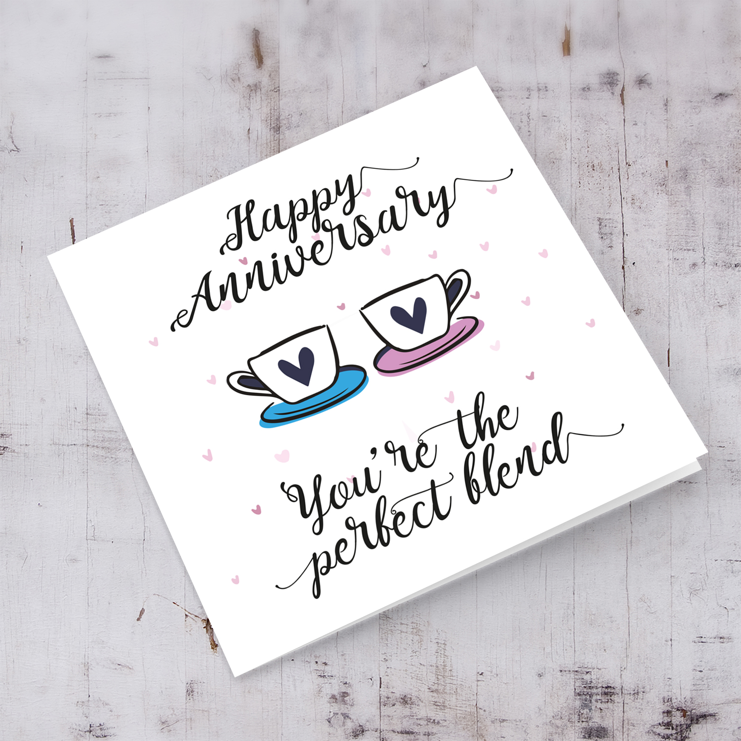 Cup themed anniversary card in English with scattered hearts 