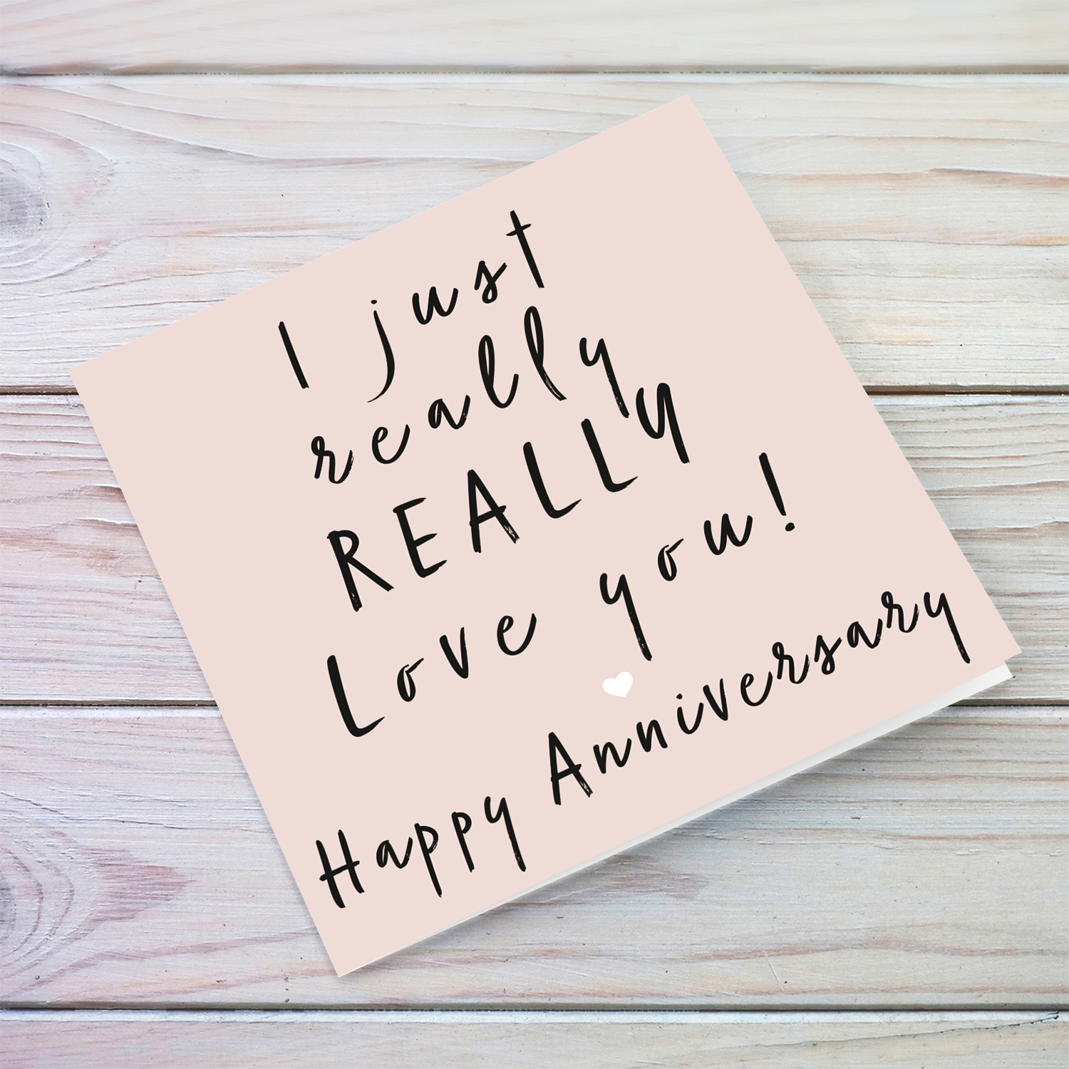 Pink background with black text Anniversary Card in English