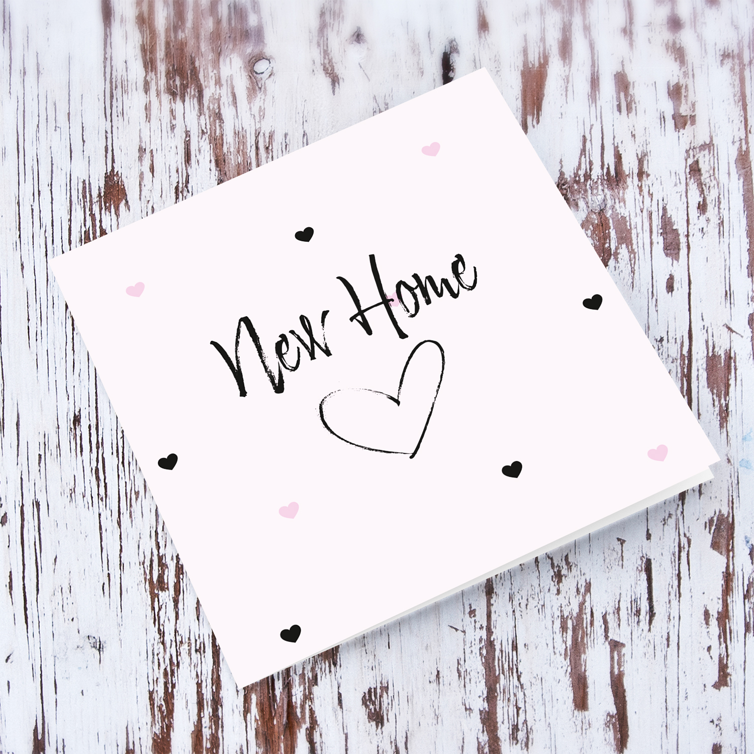 Light pink with scattered hearts new home card in English
