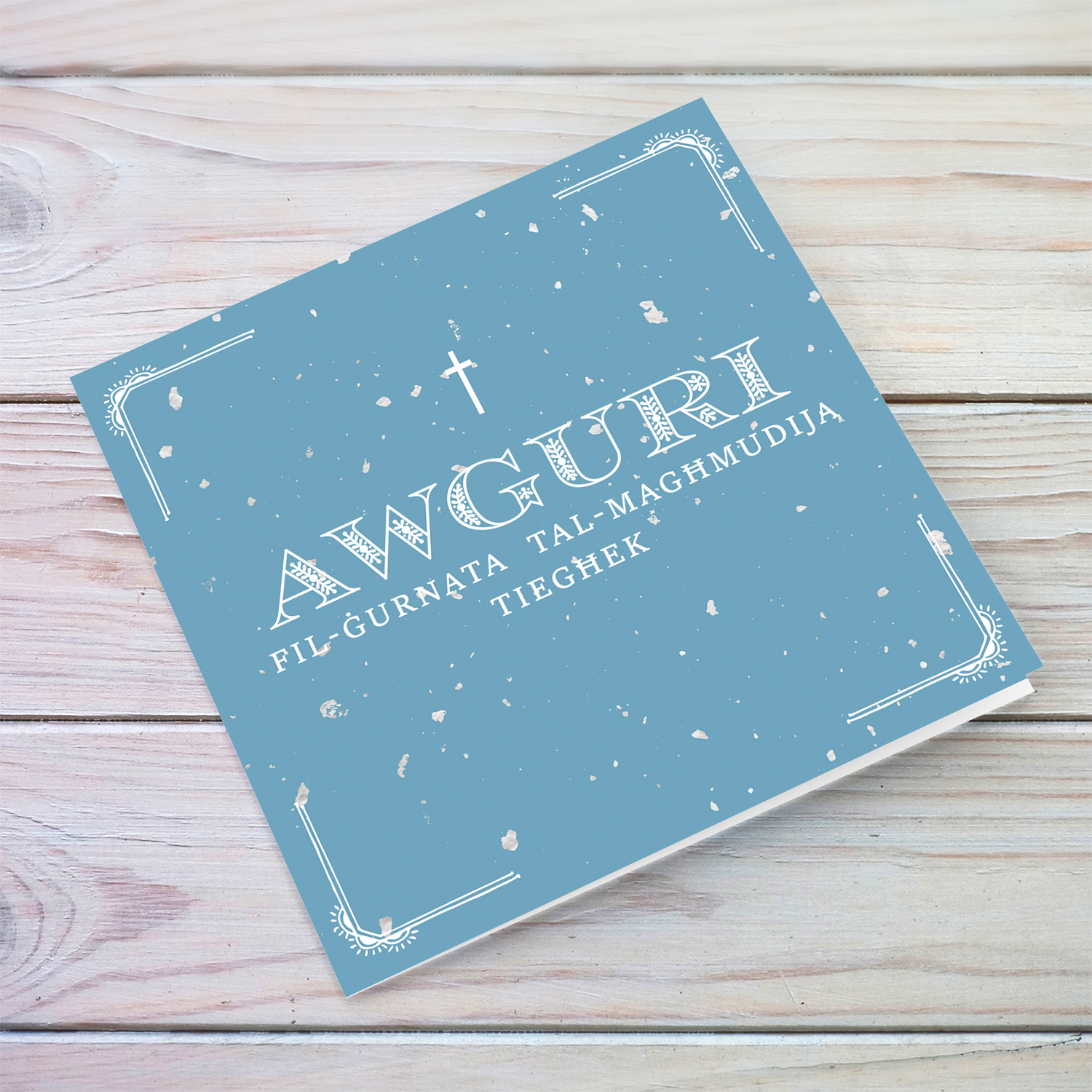 Baptism card for boy in blue speckled background and white text in Maltese