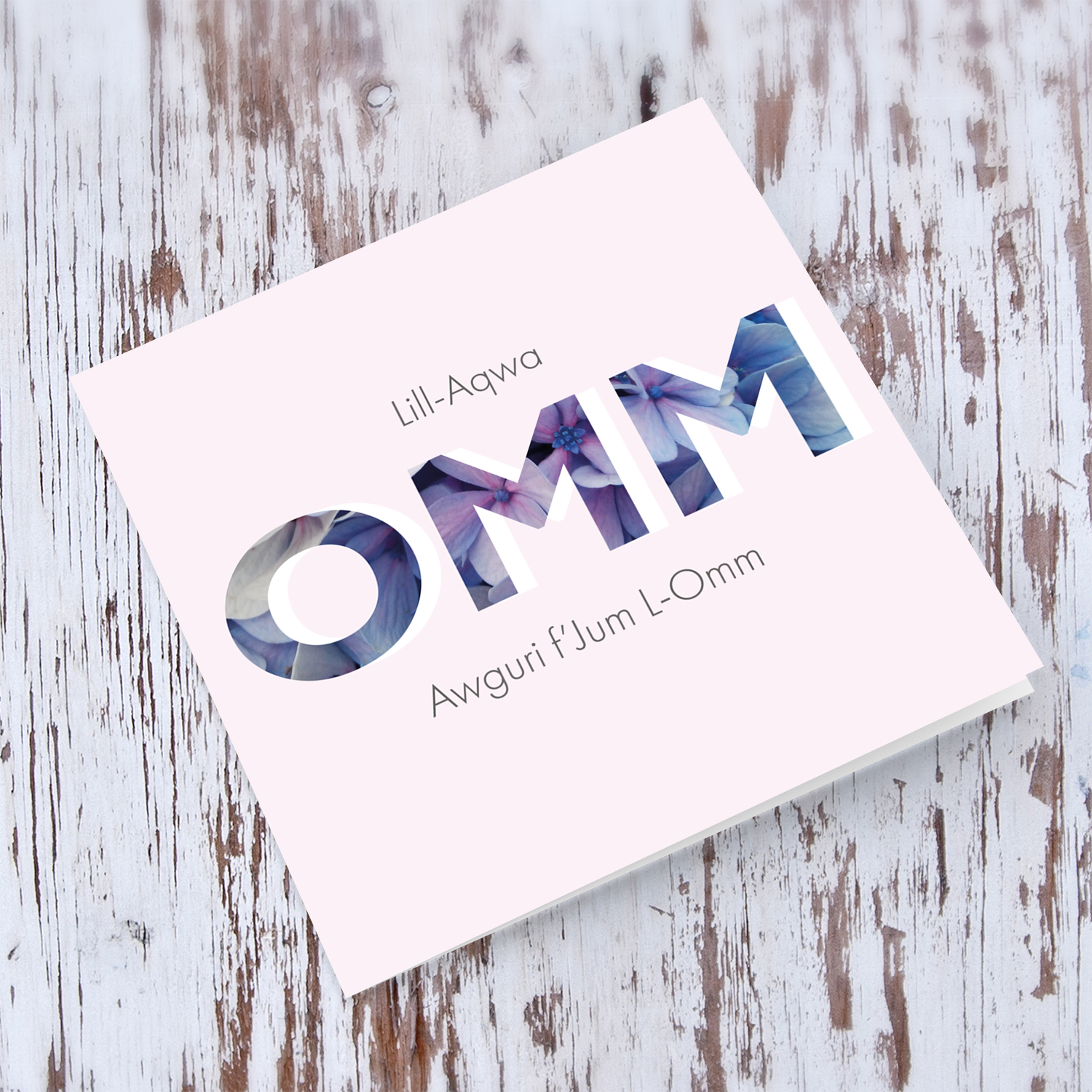 Pastel pink background with floral wording  Mother's Day Card in  Maltese