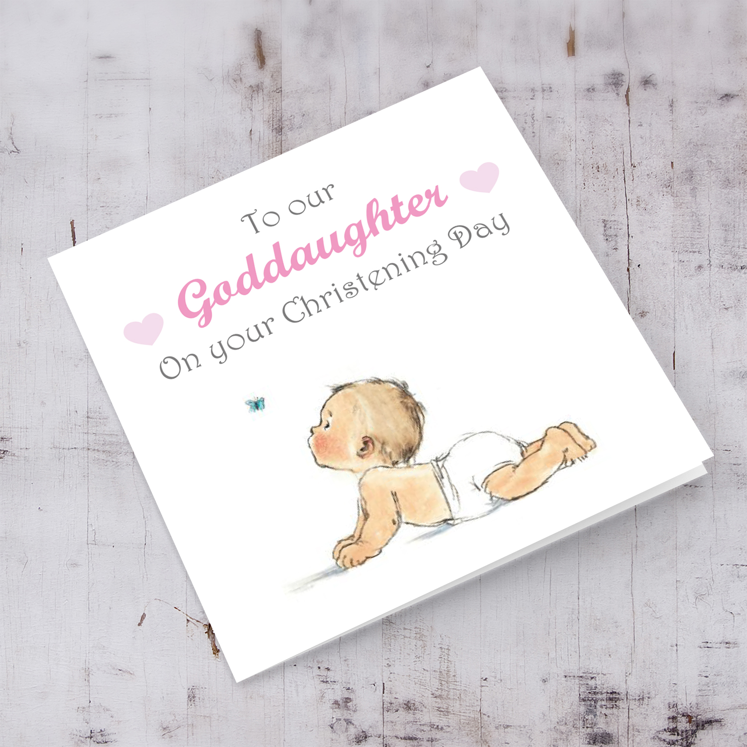 Baby with small butterfly baptism card for Goddaughter in English with pink hearts