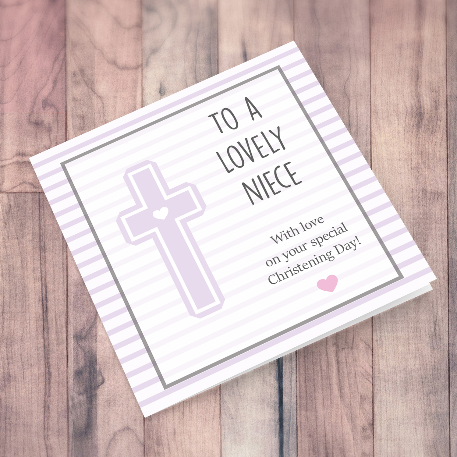 Pink striped background with a cross baptism card for a niece in English