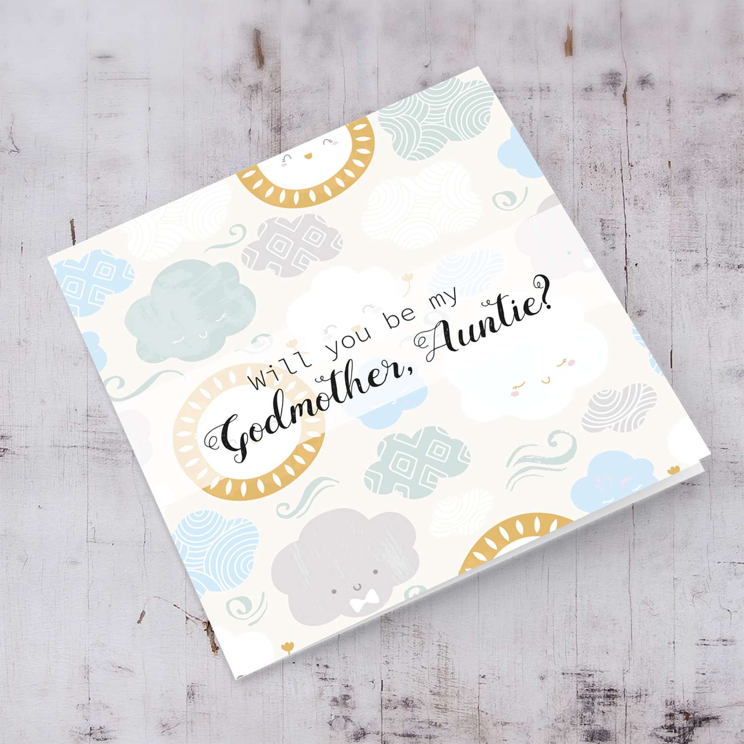 Will you be my Godmother, Auntie card in English with blue and green pastel clouds and smiling sun