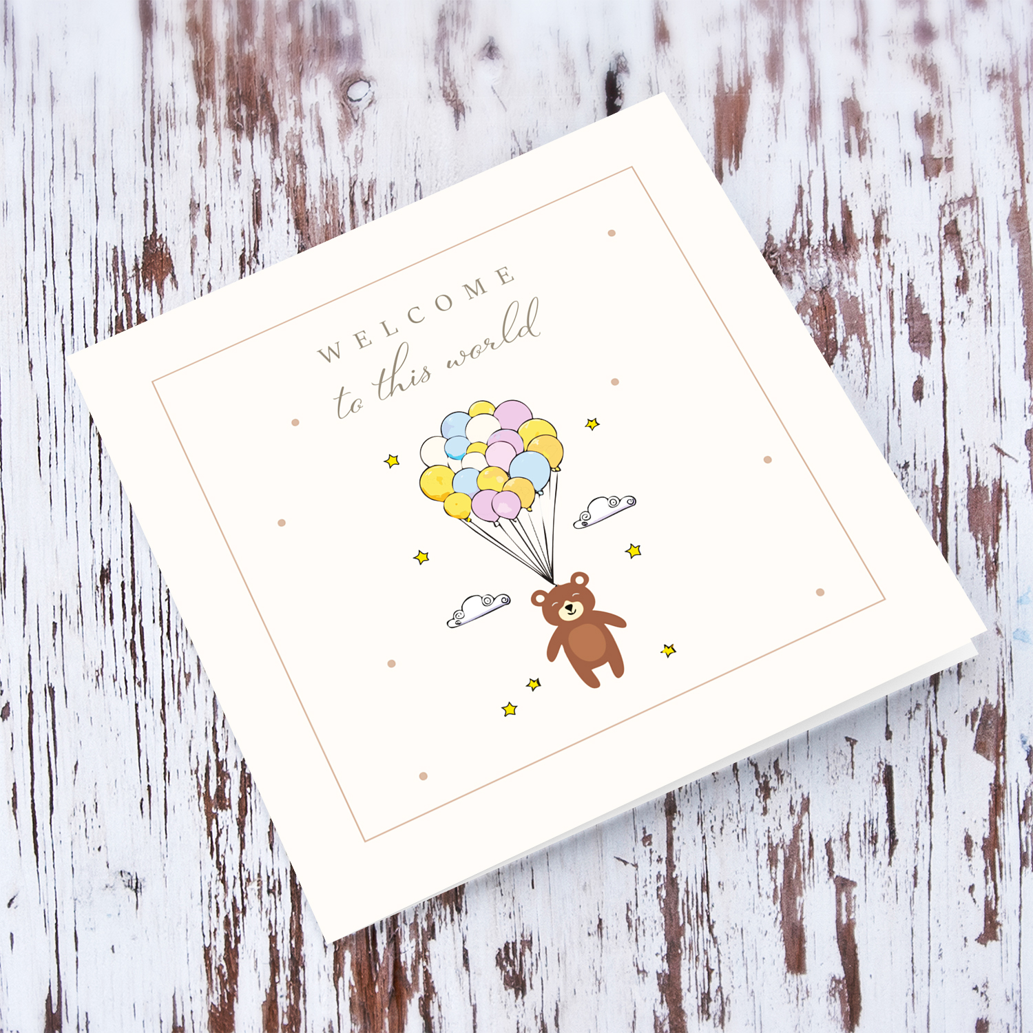 A neutral new born card featuring a cute bear with colourful balloons stars and clouds in English (Unisex)
