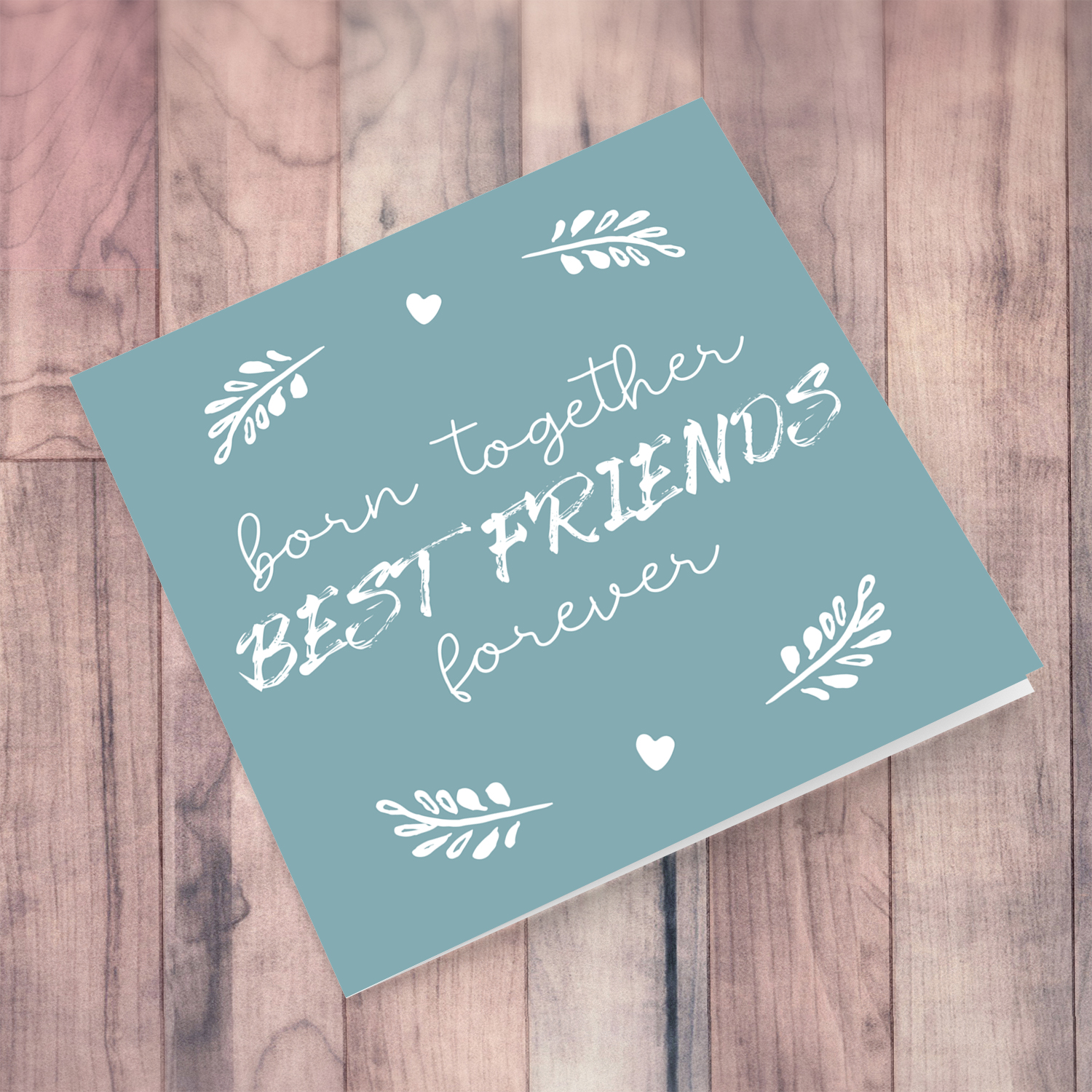 Dark turquoise background with white wording new born card for twins in English