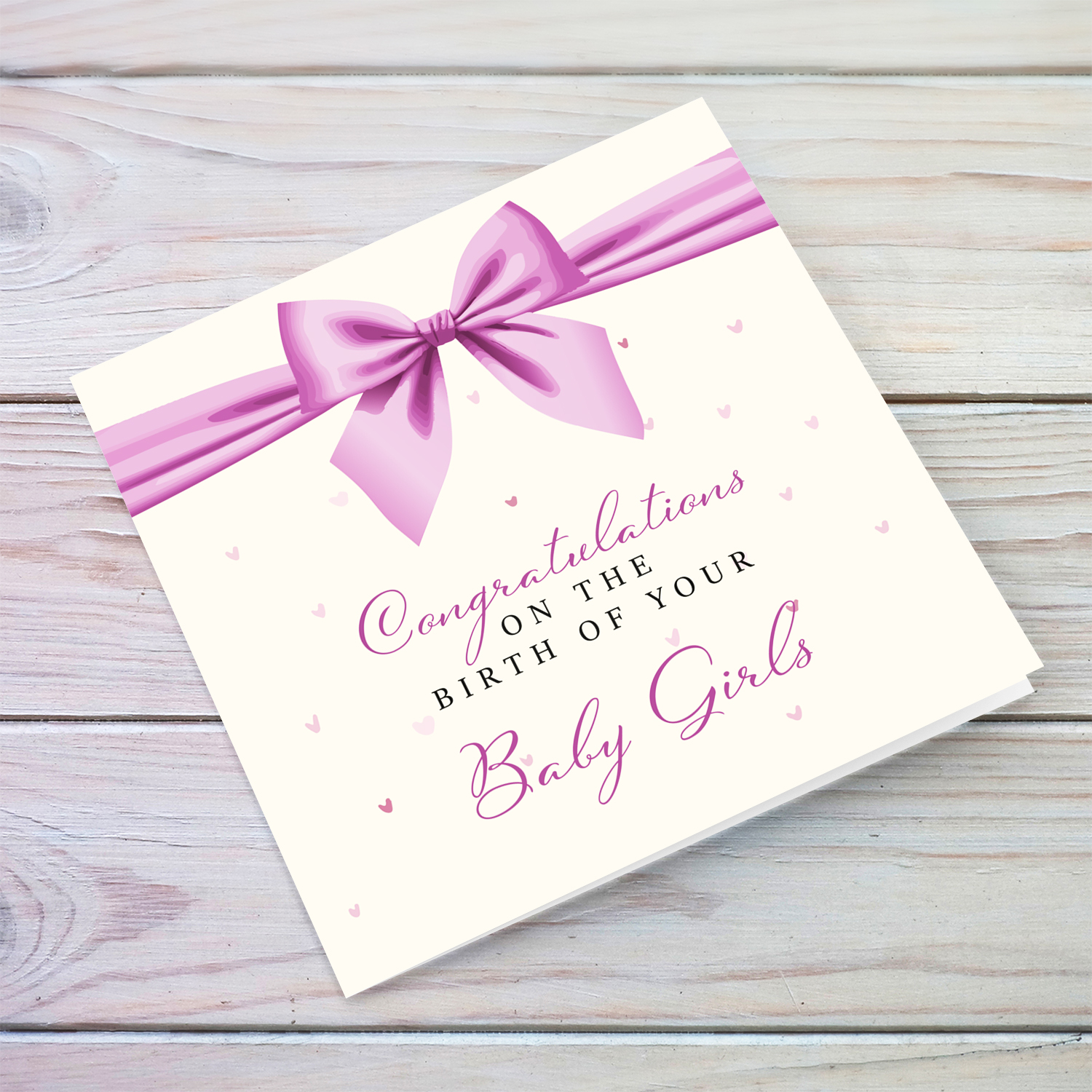 A cute new born card for twin girls featuring a pink bow in English