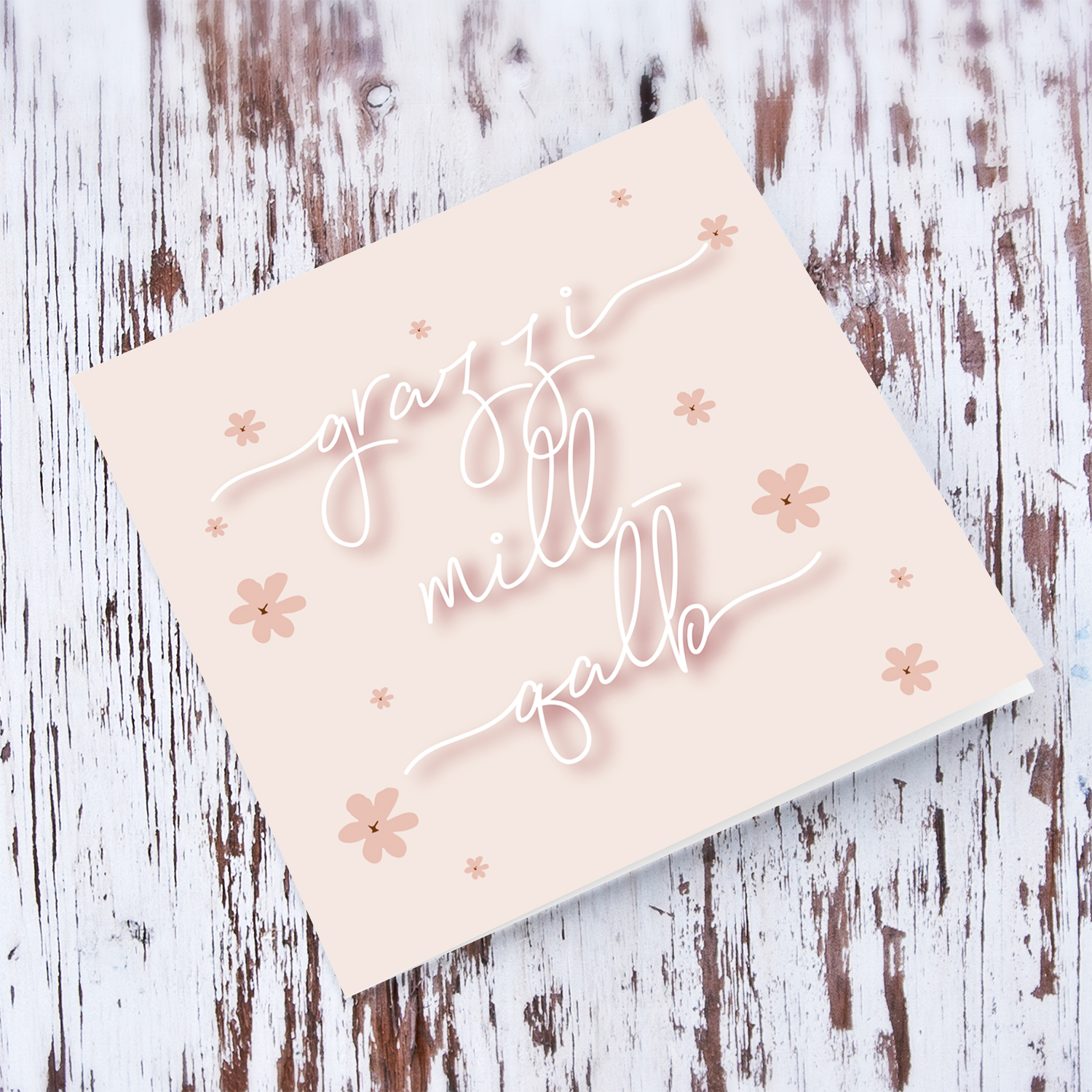 Pink background with petite scattered flowers and white text thank you card in Maltese