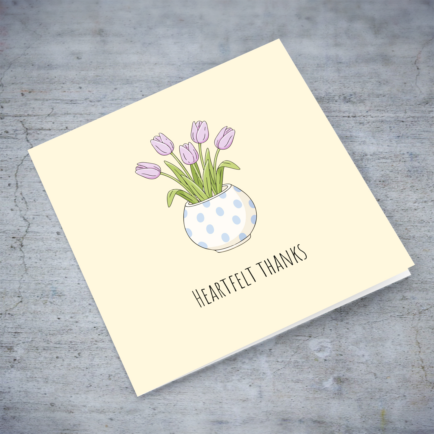 A beautiful thank you card featuring light purple tulips in spotted vase and neutral background in English