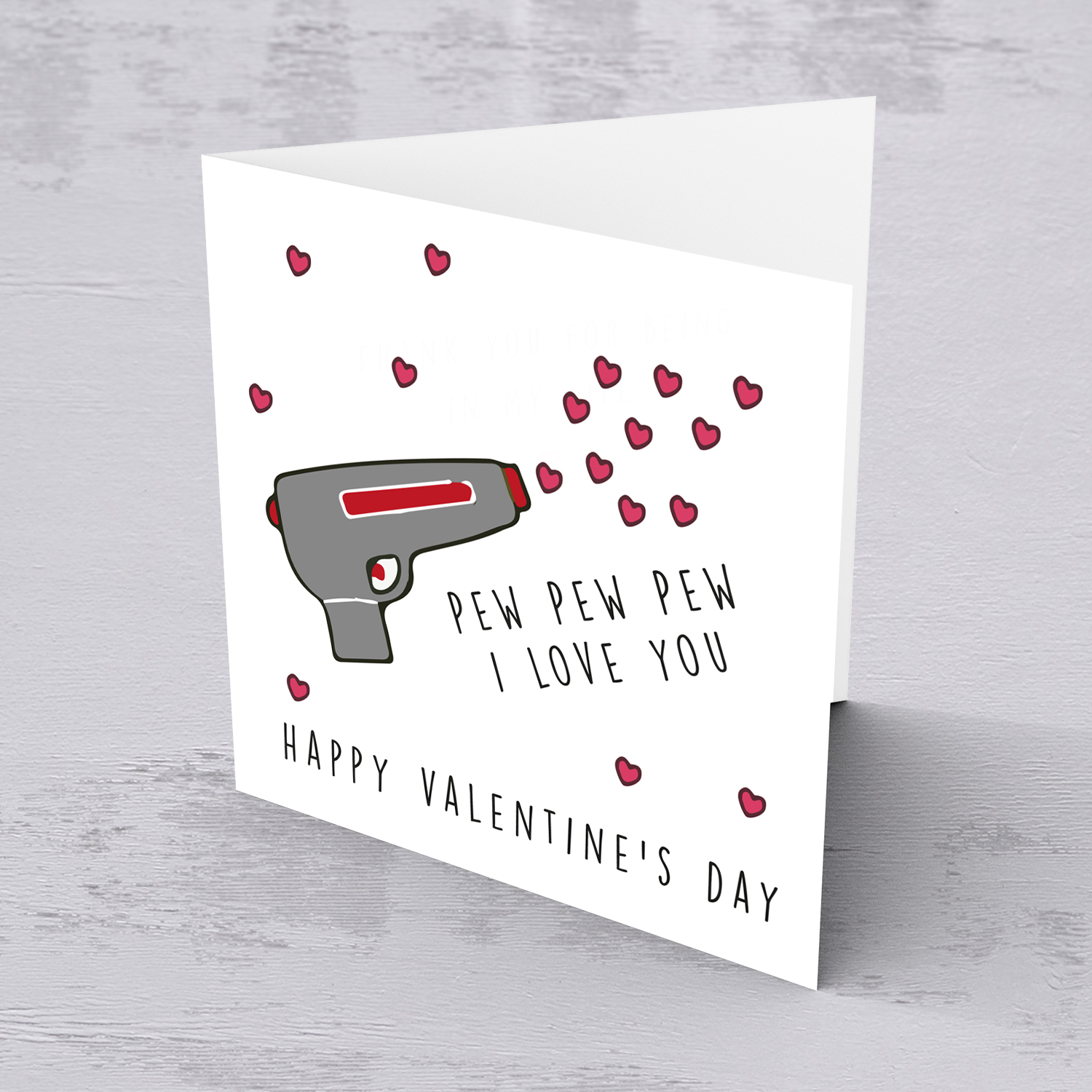 Gun shooting love hearts Valentine's Card in English