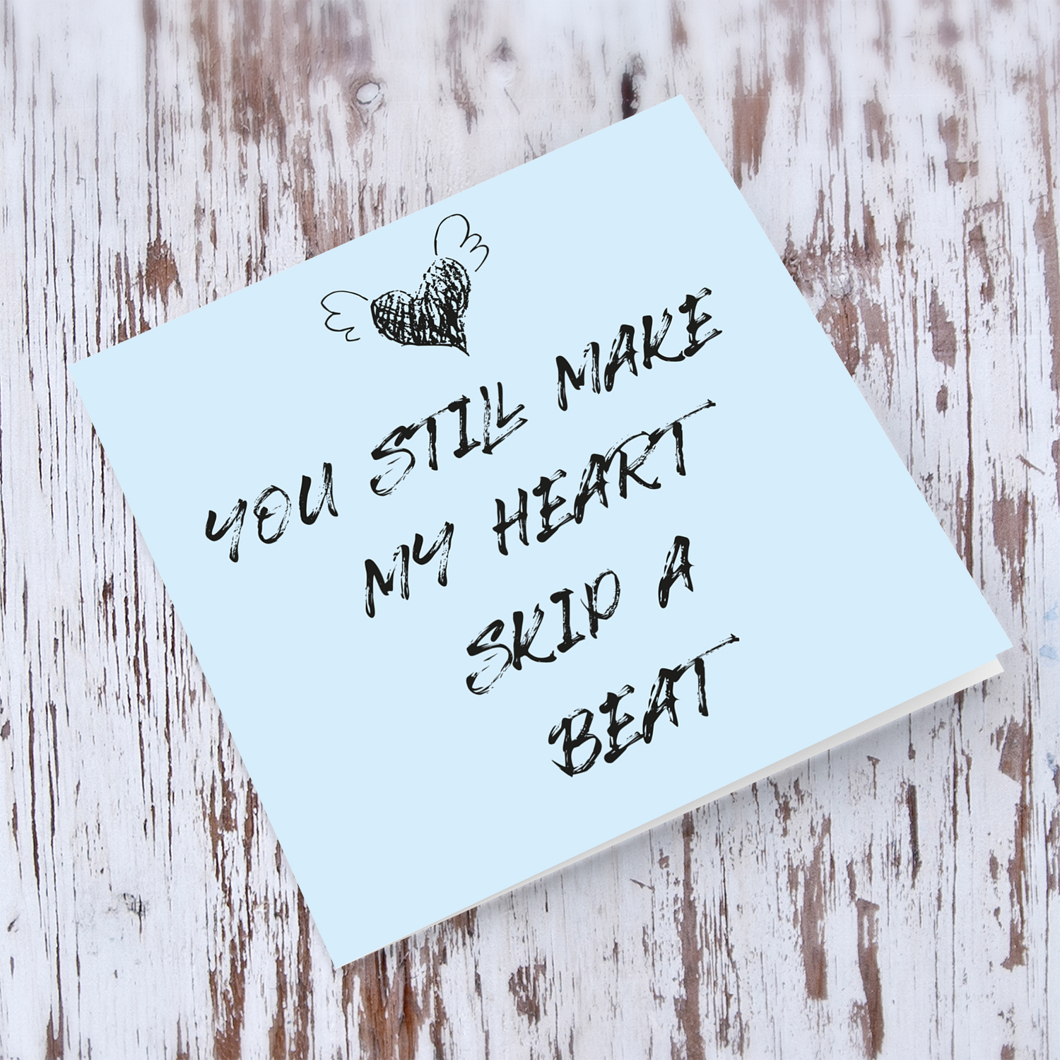Light blue background with cute heart valentines day card in English - You still make my heart skip a beat