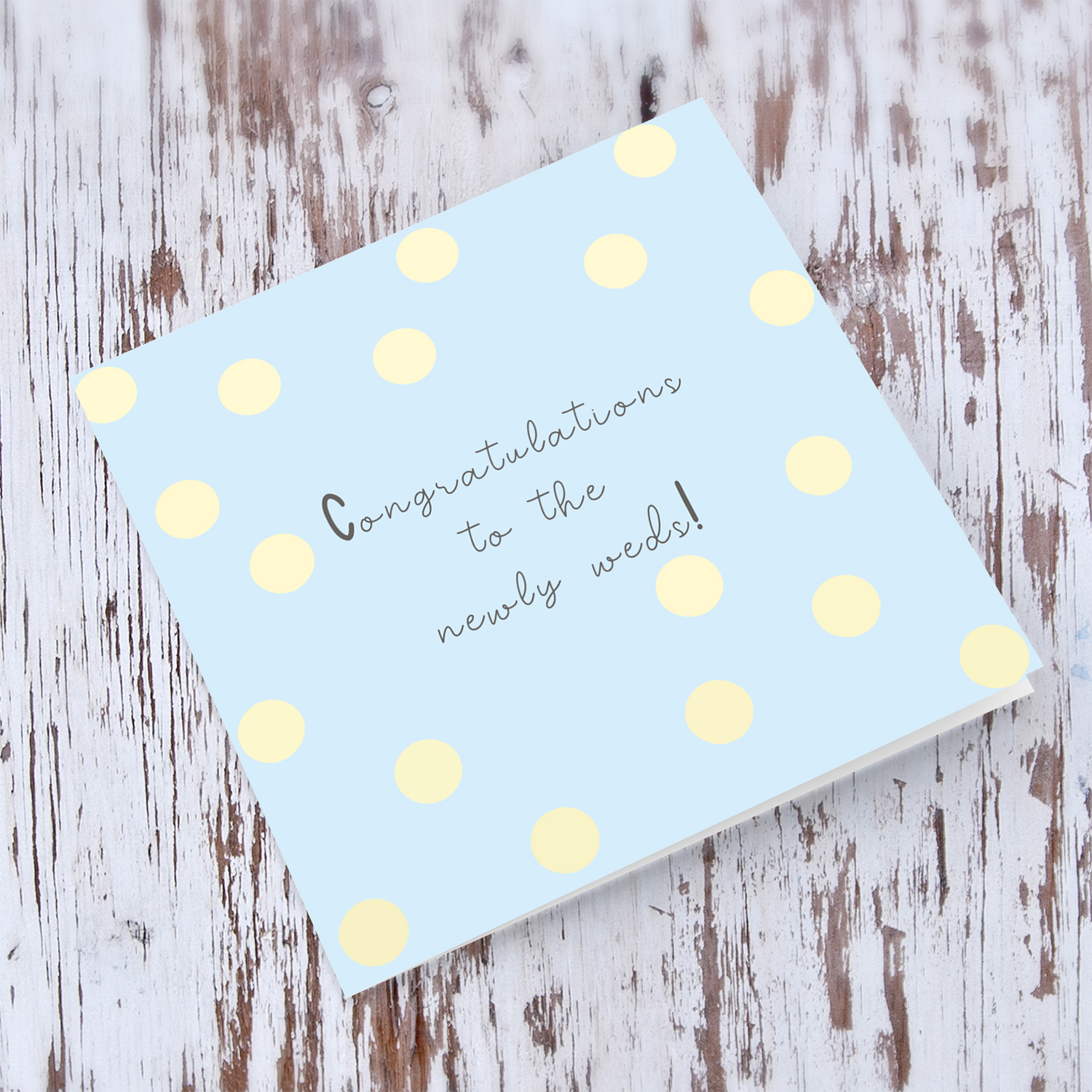 Light blue background with yellow spots wedding card in english