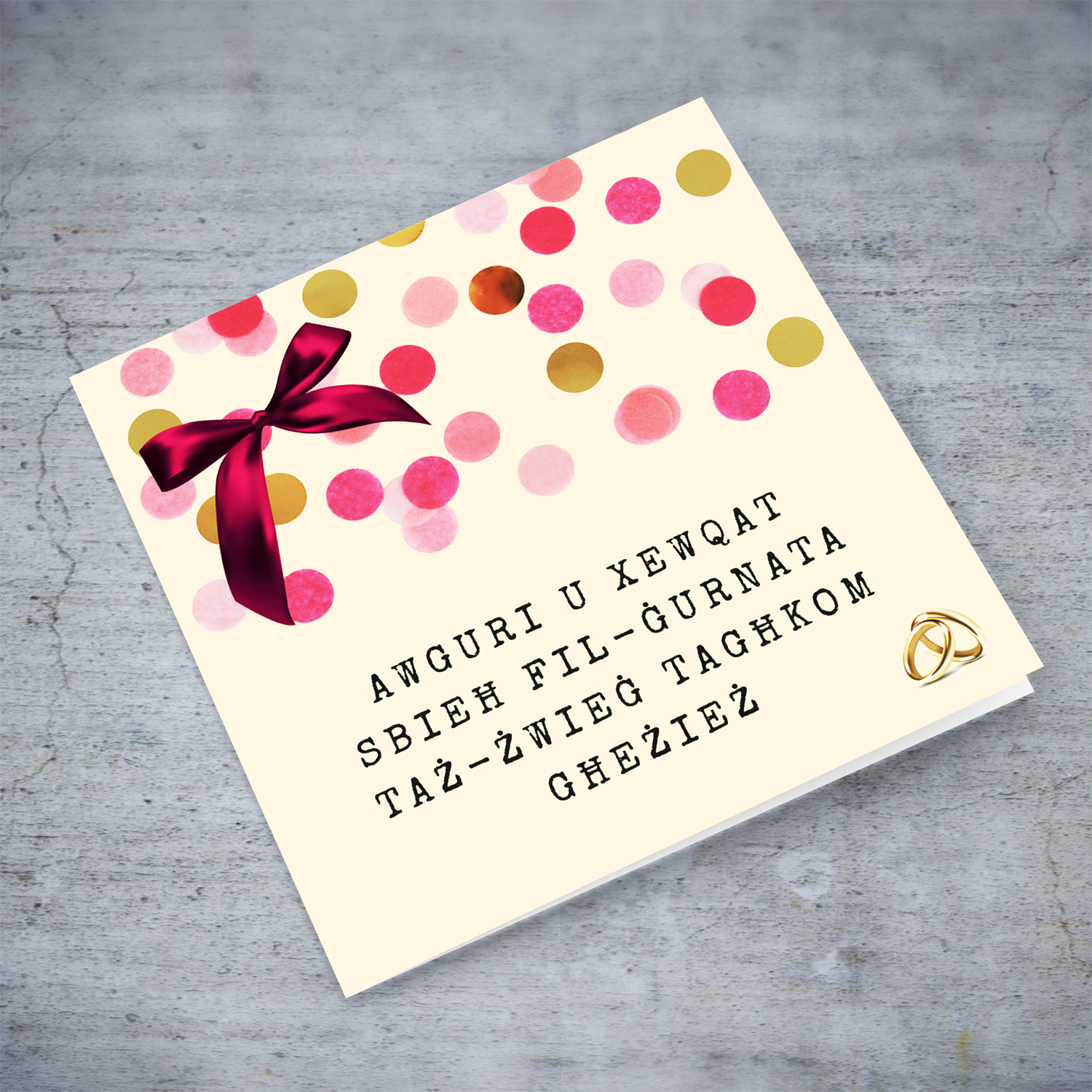 Cute wedding card with pink bow and scattered colourful confetti in Maltese