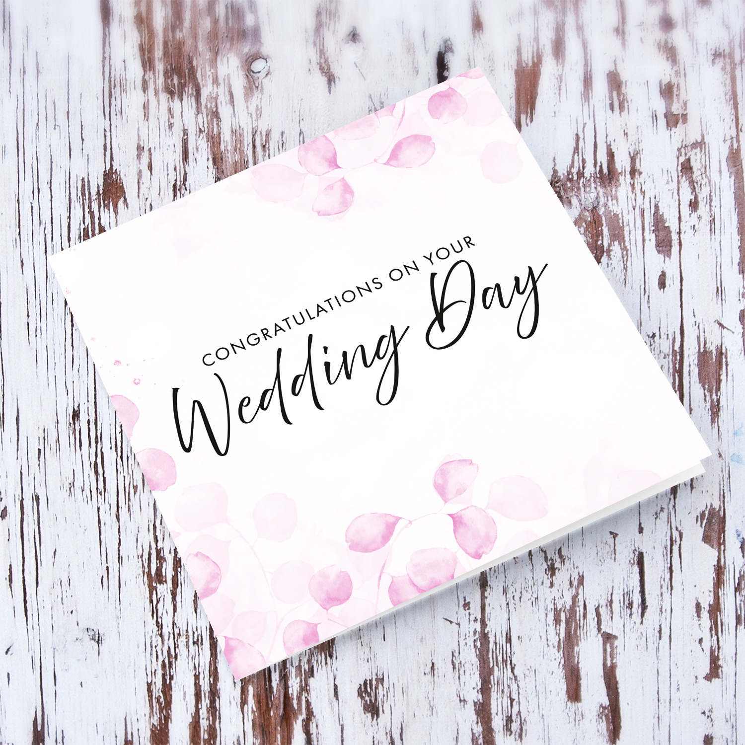 A dainty pink leave / plant background wedding card with black text in English 