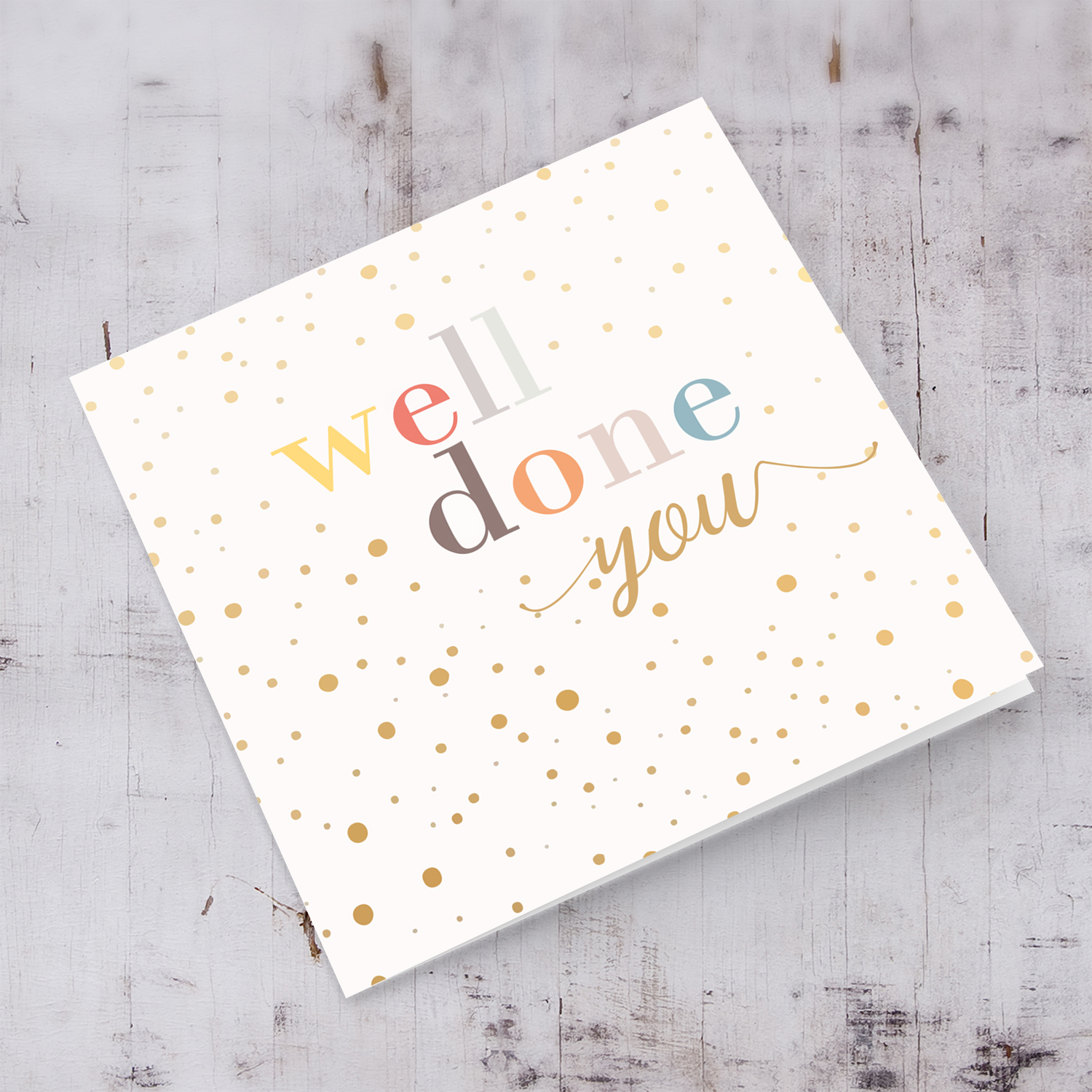 Well Done card with colourful text and scattered spots in English
